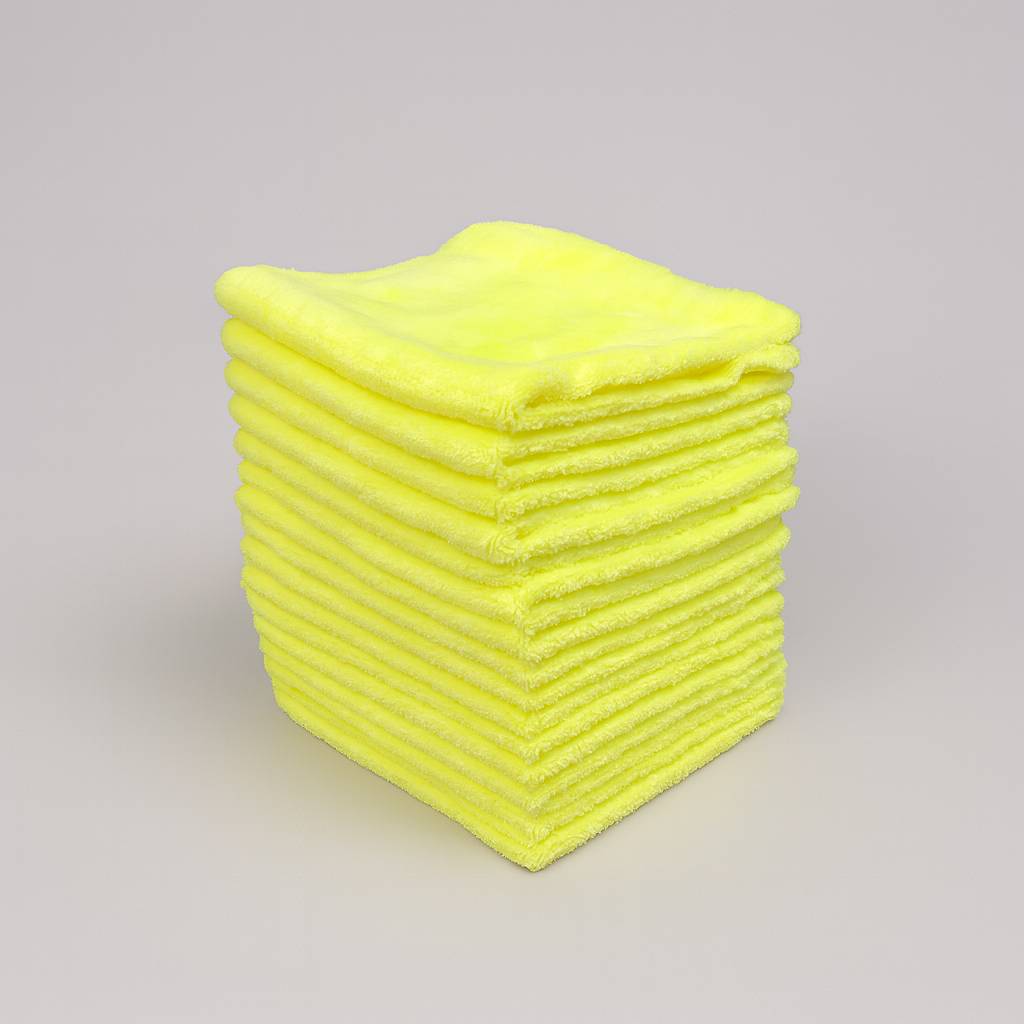 Stack of yellow microfiber cloths on a gray background