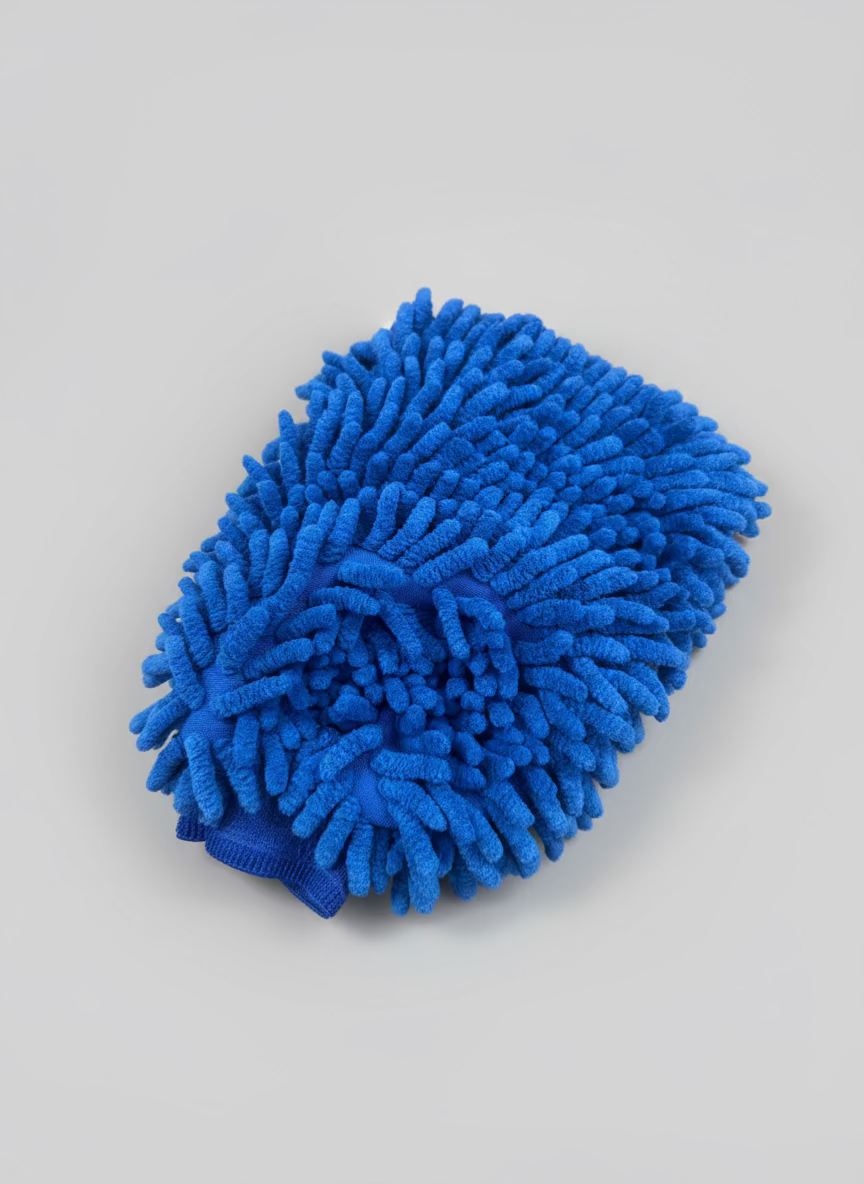 Blue microfiber cleaning mitt on a gray background
